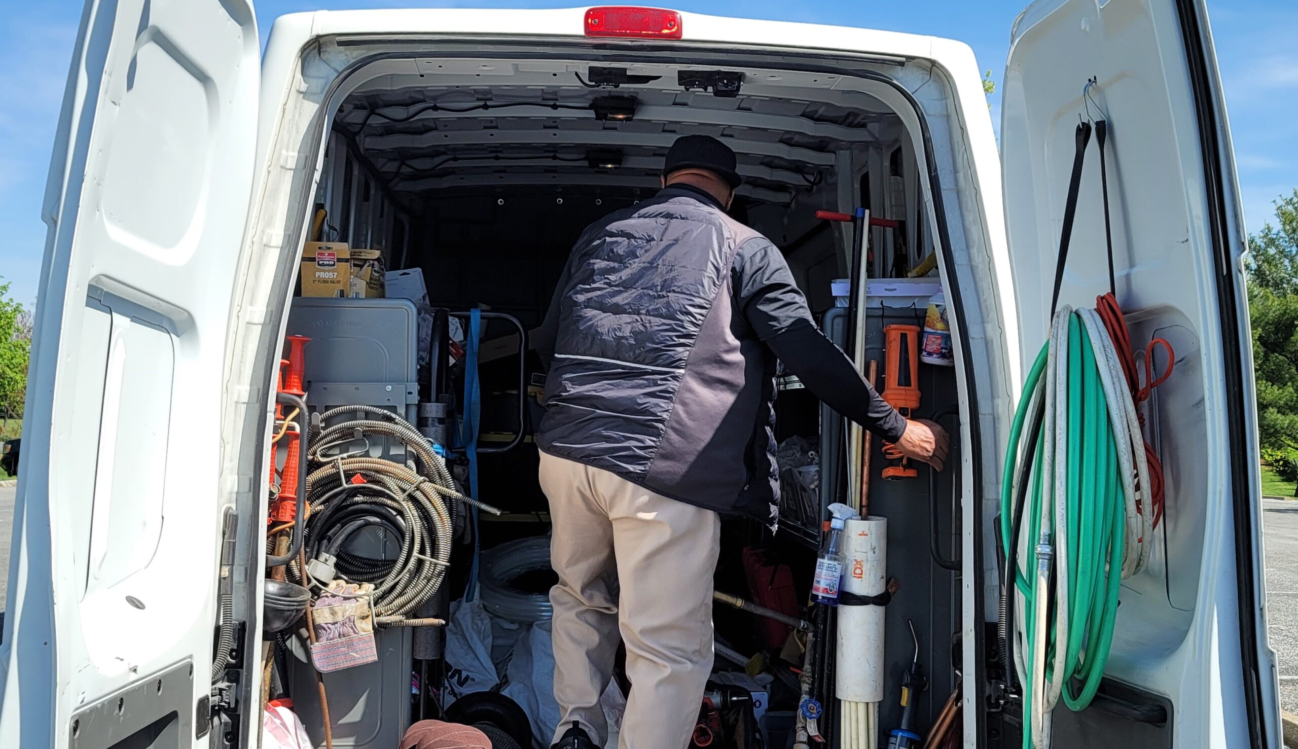 a man entering the back cabin of a van